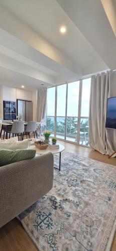 a living room with a couch and a table at Nala Host- 2BR Beachfront Apartment in Male City