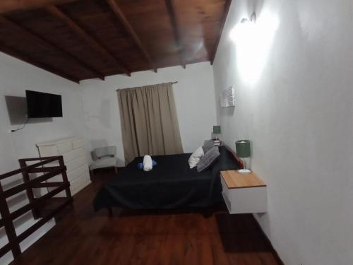 a bedroom with a bed and a television in it at Departamento en Dolores Precio exclusivo en entrada a Parque Termal in Dolores