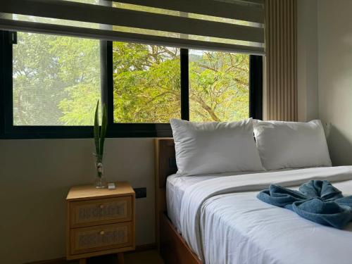 a bedroom with a bed and a large window at Inngo Tourist Inn in El Nido