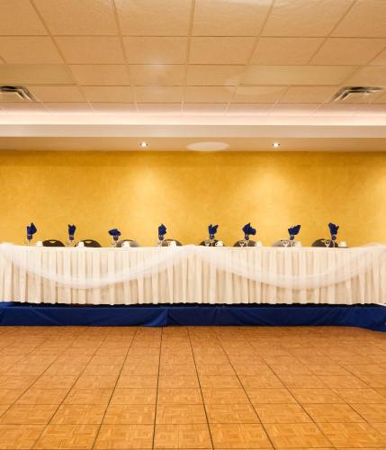 a room with a table with chairs in it at Park West Inn in Winnipeg