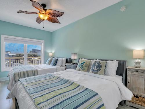 a bedroom with two beds and a ceiling fan at Relax-Unwind-Enjoy in Tybee Island