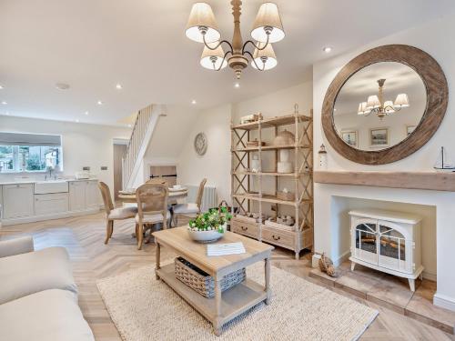 a living room with a fireplace and a large mirror at 2 Bed in Cockermouth 95716 in Broughton Moor