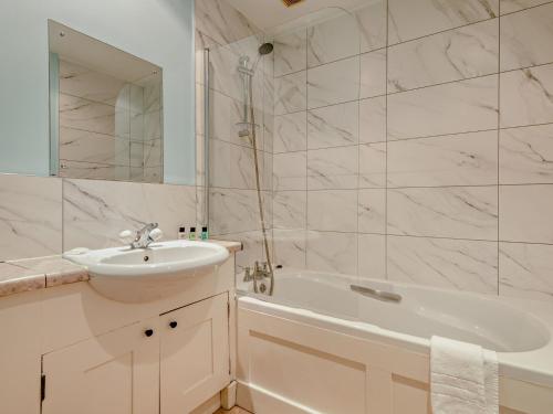 a white bathroom with a sink and a bath tub at 2 Bed in Sedgehill 96237 in Sedghill