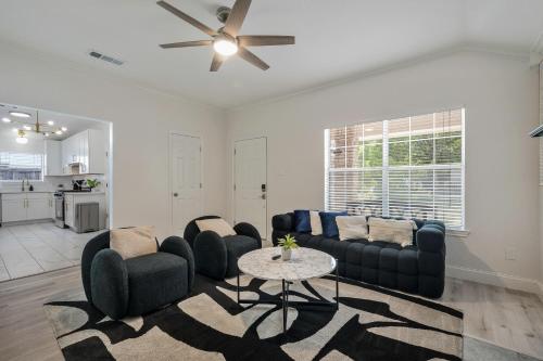 a living room with a couch and a table at Modern 3BR in Bishop Arts Walk to Shops in Dallas