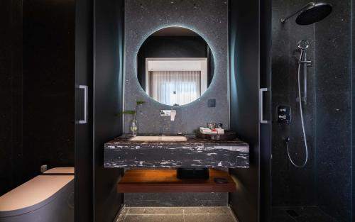 a bathroom with a sink and a mirror at Wangye Homestay Collection, Dali Ancient Town in Dali Ancient Town