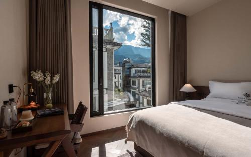 a bedroom with a bed and a large window at Wangye Homestay Collection, Dali Ancient Town in Dali Ancient Town