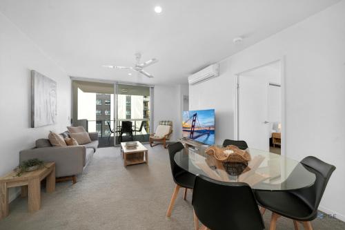 a living room with a glass table and chairs at Mowbray East Apartments in Brisbane