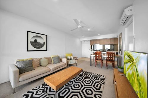 a living room with a couch and a table at Mowbray East Apartments in Brisbane