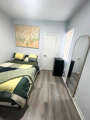 a bedroom with a bed and a mirror at Cozy Private Room Near Downtown Toronto in Toronto