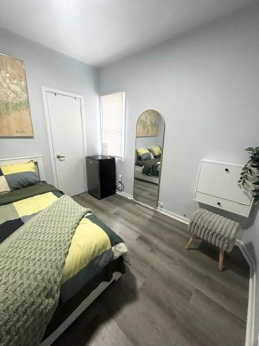 a bedroom with a bed and a dresser and a mirror at Cozy Private Room Near Downtown Toronto in Toronto