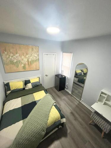 a bedroom with a bed and a mirror at Cozy Private Room Near Downtown Toronto in Toronto