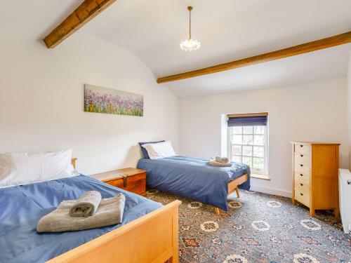 a bedroom with two beds and a window at 3 Bed in Coleford 89806 in Coleford