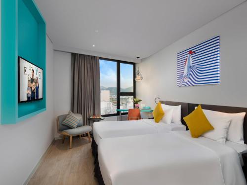 a hotel room with two beds and a window at ibis Styles Nha Trang in Nha Trang