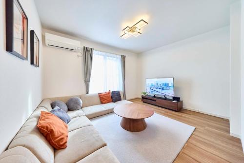 a living room with a couch and a table at Villa Sumida Five in Tokyo