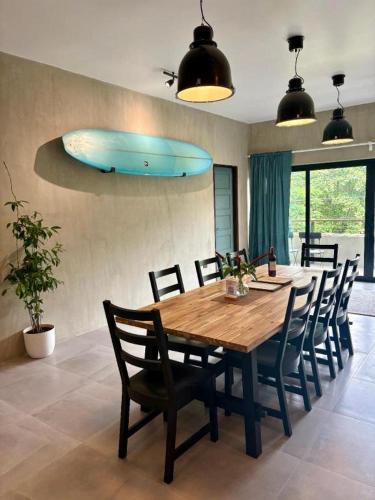 a dining room with a wooden table and chairs at Buddha Resort in Catagnan