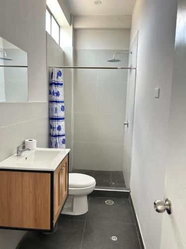 a bathroom with a toilet and a sink and a shower at Casa Laguna in Trujillo