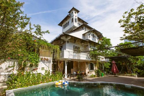 a house with a swimming pool in front of it at Villa 750sqm with Pool and BBQ in Hue in Cồn Giả Viên
