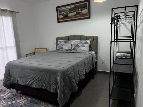 a bedroom with a bed with a black bed frame at Sítio Bela Vista in Angra dos Reis