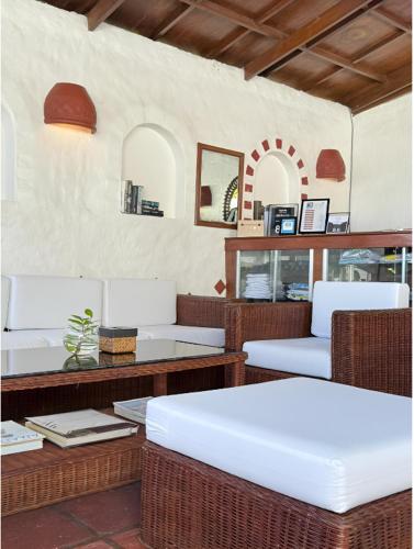 a restaurant with wicker chairs and a table and tables at Steps Garden Resort in Sabang