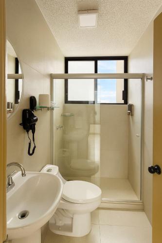 a bathroom with a toilet and a sink and a shower at Depamor in Morelia
