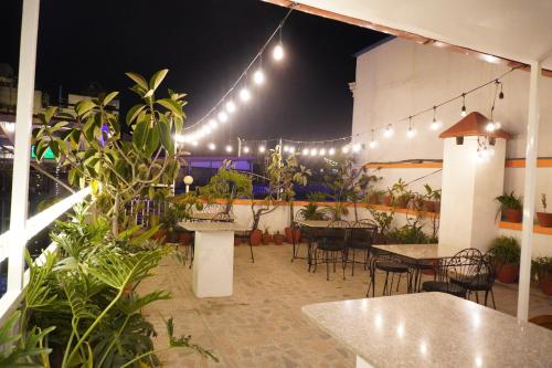 a restaurant with tables and chairs and lights at Khangsar Home in Kathmandu