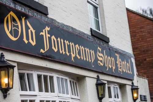 a sign on the side of a building at The Old Fourpenny Hotel in Warwick