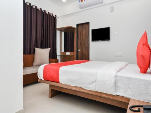 a bedroom with a large bed and a tv at Flagship The Address in Deolāli