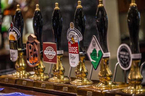 a group of bottles of beer on a table at The Old Fourpenny Hotel in Warwick