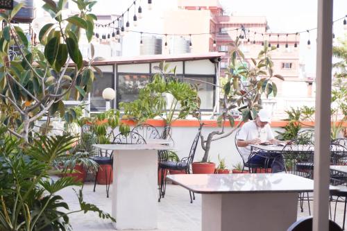 a man sitting at a table on a patio at Khangsar Home in Kathmandu