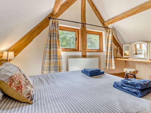 a bedroom with a bed with blue towels on it at 5 Bed in Ludlow 95212 in Tugford