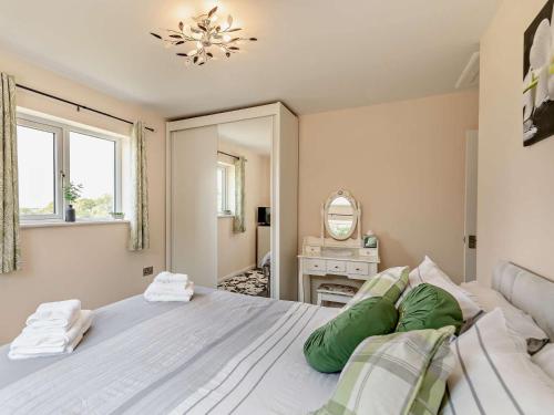 a bedroom with a large bed and a mirror at 2 Bed in Launceston 52087 in Virginstow