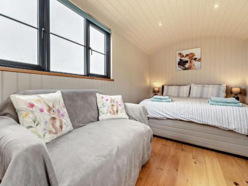 a living room with a couch and a bed at 1 Bed in Uplowman 96190 in Uplowman