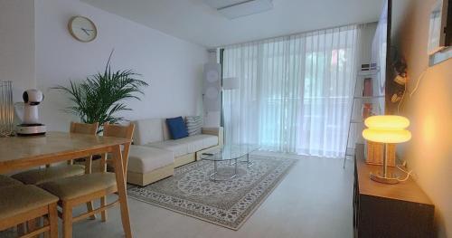 a living room with a couch and a table at Daegu 3 rooms APT All furnished Near downtown & Dongdaegu station in Daegu