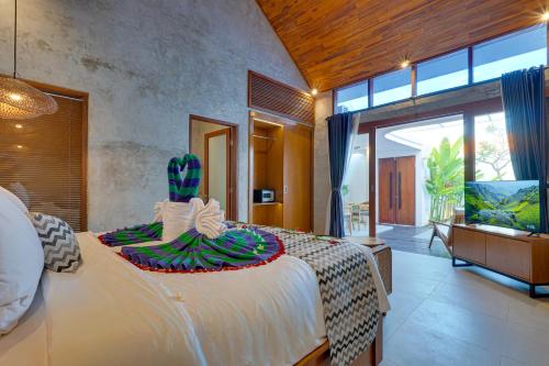 a bedroom with a large bed with a cactus on it at Sweet Escape 1BR Matahari LaLuxe A22 Sanur Villa in Sanur