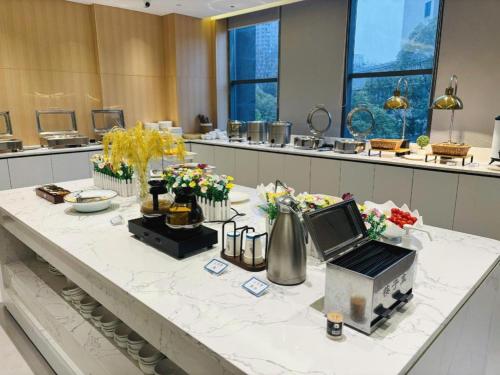 a room with a table with flowers on it at Lavande Hotel Yichang Railway East Station Branch in Yichang