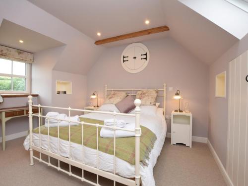 a bedroom with a white bed and a desk at 2 Bed in Peebles 76383 in West Linton
