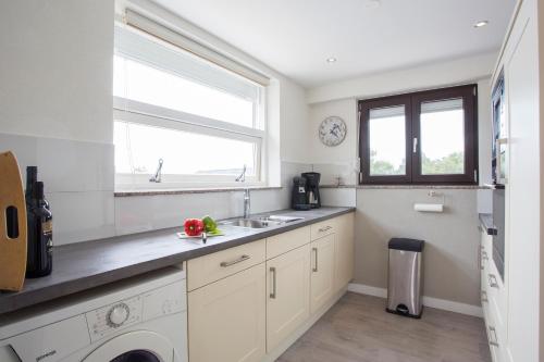 a kitchen with a sink and a washing machine at Galizana Peaceful Vacation home in Galižana
