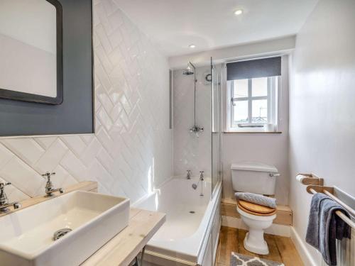 a bathroom with a sink and a toilet and a shower at 3 Bed in Newby Bridge 87960 in Greenodd