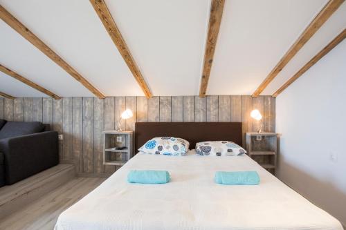 a bedroom with a large bed with two blue pillows at Galizana Peaceful Vacation home in Galižana