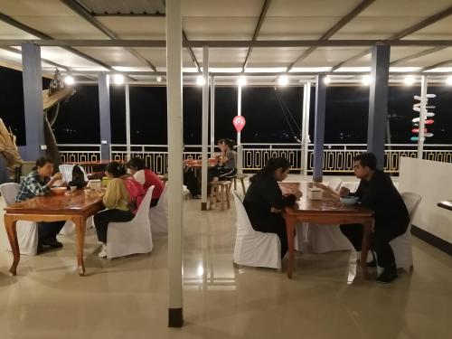 un groupe de personnes assises à des tables dans un restaurant dans l'établissement ชมวิว บึงโขงหลง, à Bung Khong Long