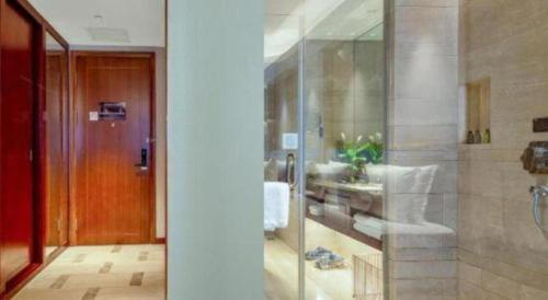 a bathroom with a glass shower and a sink at Days Hotel by Wyndham Hunan Changsha Convoy in Changsha