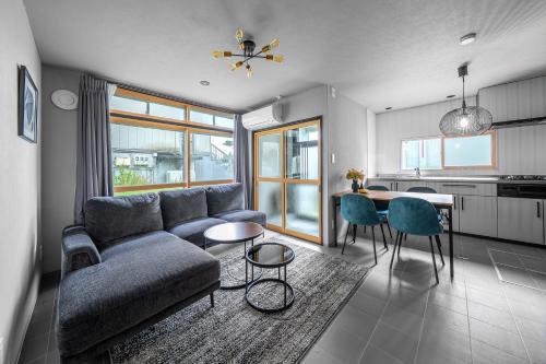 a living room with a couch and a table at Akatsuki in Kami-furano