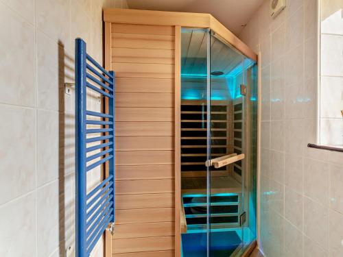 a shower with blue glass doors in a bathroom at 8 Bed in Pateley Bridge 95111 in Sawley