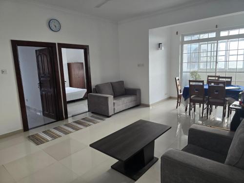 a living room with a couch and a table at Beachfront City Escape Sunset Balcony AC WiFi in Colombo