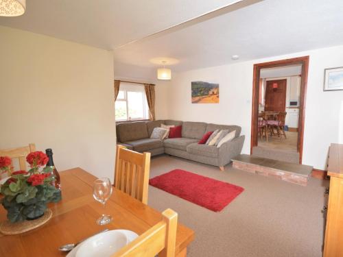 a living room with a table and a couch at 2 Bed in Sidmouth BURSC in Sidbury