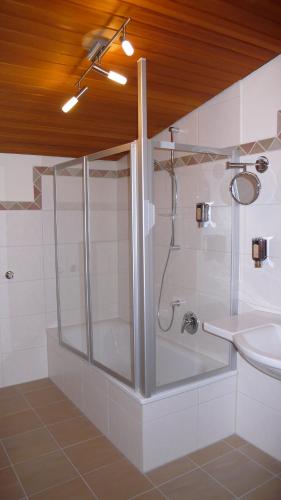 a bathroom with a shower and a sink at Hotel Gasthof Käßer in Ansbach
