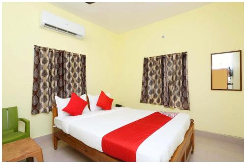 a bedroom with a large bed with red pillows at Hotel Nandan- Residency Near Bus Stand-Nandankanan Zoo- Fully Air Conditioning Hotel - Luxury & Spacious Room -A Premium Hotel in Cuttack
