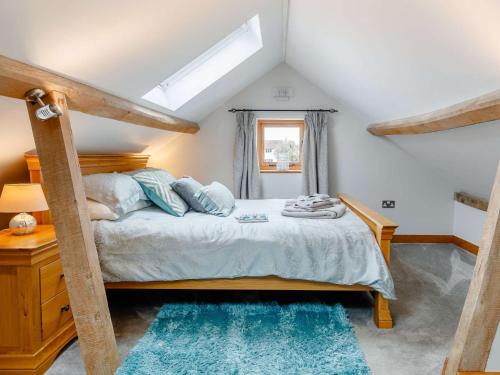 Schlafzimmer mit einem Bett mit blauen Teppichen in der Unterkunft 1 Bed in Cheltenham 60276 in Tirley