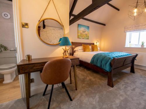 Un dormitorio con una cama, un escritorio y un espejo. en 1 Bed in Richmond 88589, en Easby