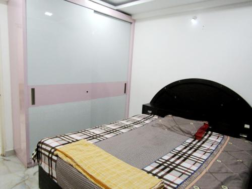 a room with a bed in the corner of a room at Serenity Homes Near Rushikonda in Visakhapatnam